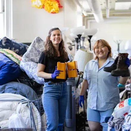 Jena Kim and Molly Neu sorting through items at SmithCycle in 尺度上的房子 basement